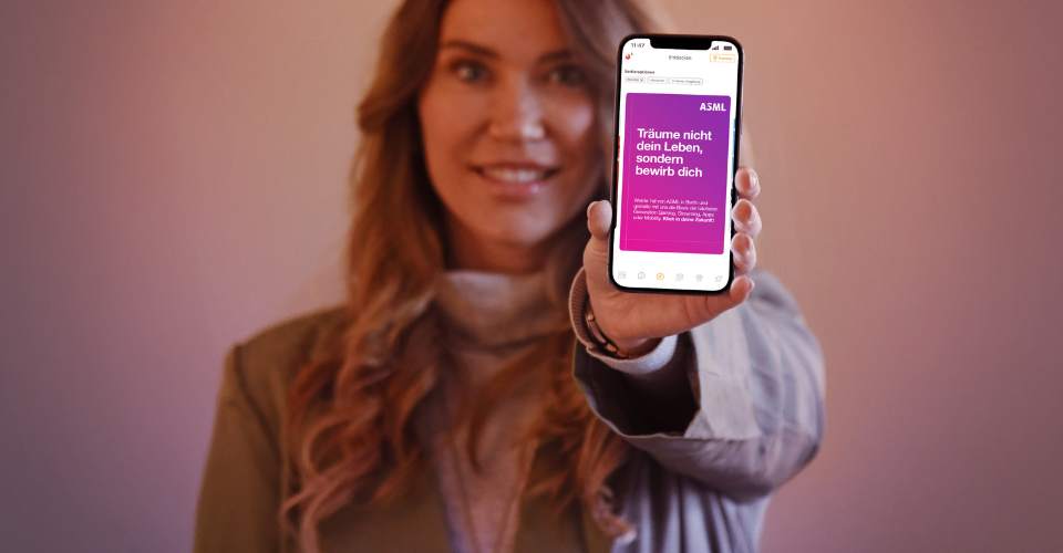 Eine Frau zeigt ein Smartphone mit dem Recruiting-Screen der scoolio-App